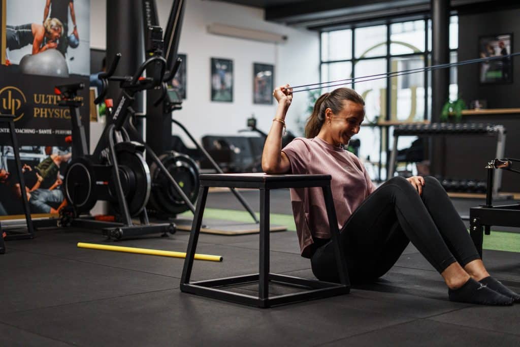 Coach nutrition Bordeaux : une cliente souriante pendant sa séance chez Ultimate Physical, où le coaching s'accompagne d'un suivi de la nutrition